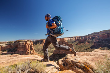 Hiker is sitting on the cliff in Colorado National monument, USA