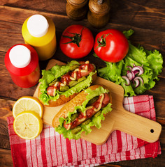 Hot dogs with salad, tomatoes, ketchup and mustard