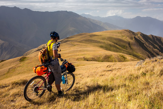 Mountain biker is checking gps location after Atsunta pass in the highlands of Tusheti region, Georgia