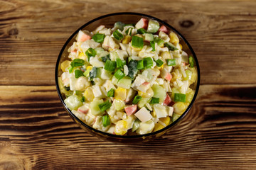 Salad with crab sticks, sweet corn, cucumber, eggs, rice and mayonnaise