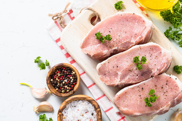 Pork meat steak on white top view. 