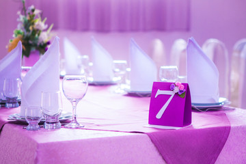 decorating a festive table in purple color for wedding