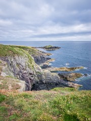Caerfai Beach footpath area seascape view on a cloudy day West Wales UK.