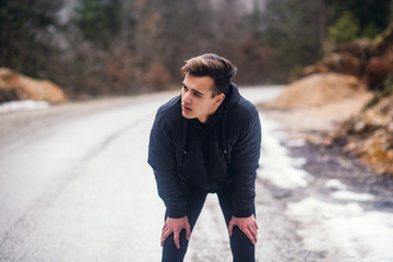 Man take a break after run at winter day