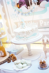 cake with mastic and a snowman stands on the tray in the restaurant