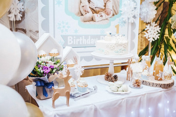 sweet table with cake, macarons, muffins and juices for children and adults