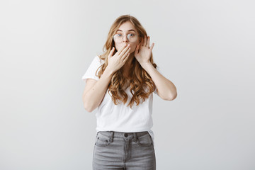 Breathtaking rumor. Portrait of interested excited cute woman with blond hair in glasses, holding...