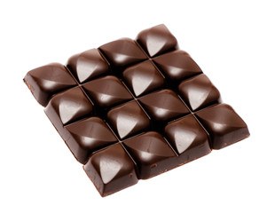 Full chocolate pieces. Chopped dark chocolate closeup isolated