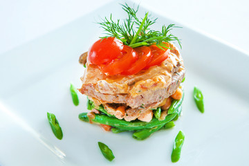 salad of green beans with meat and vegetables is on the plate