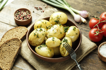 Summer dinner set with potatoes, summer vegetables, with young onions and tomatoes.