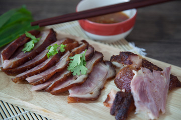 roasted pork leg in wooden plate.