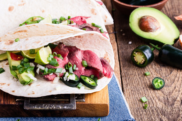 Mexican tacos with beef steak and vegetables