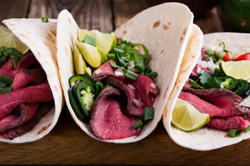 Mexican tacos with beef steak and vegetables