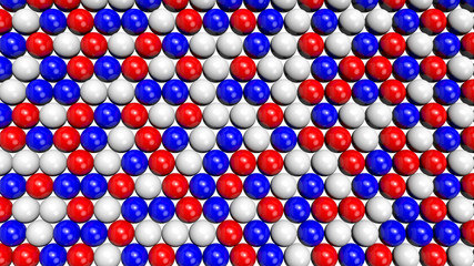 Red, white and blue shiny spheres forming a background pattern. Computer generated 3D illustration.