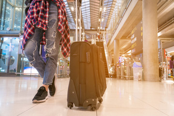 Young woman wearing casual clothes is posing at airport. Copy space.