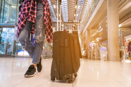 Young woman wearing casual clothes is posing at airport. Copy space.