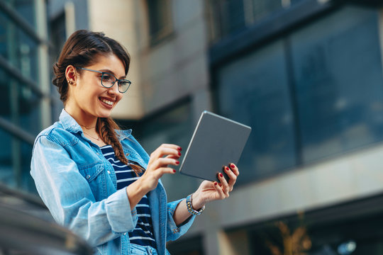 Young Woman Usinga Digital Tablet In The City