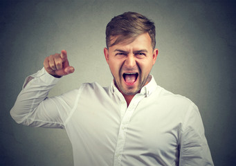 Angry man pointing at camera in blame