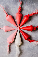 Piping bags with colors range from white to red, with different gradation over a gray background
