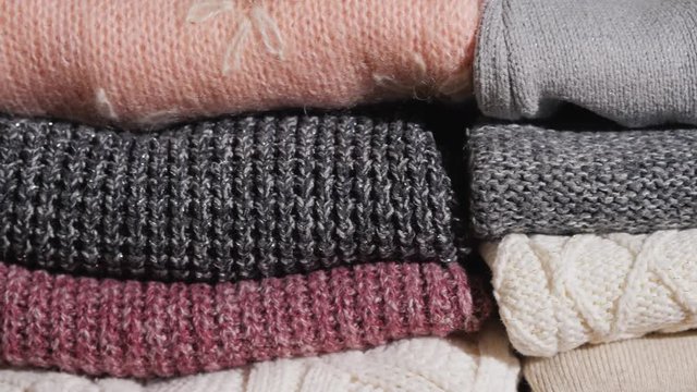 Slider video: Neatly folded winter clothes.