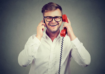 Cheerful man comparing old and new technology