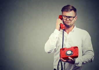 Confused man speaking on phone