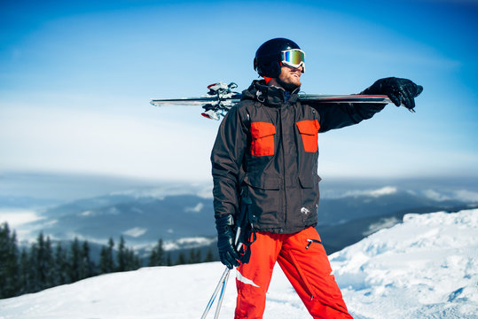 Skier with skis and poles in hands, winter sport
