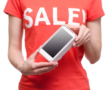 Woman with t-shirt with an inscription sale in hand smartphone mobile phone shop buy discount