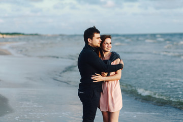 loving couple hugging at sunset at sea