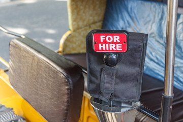 Interior of an Auto rickshaw. Written for hire on the meter box.