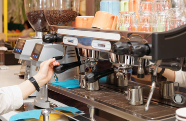Barista is brewing coffee in a cafe