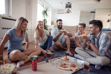 Group of friends eating pizza snack at home