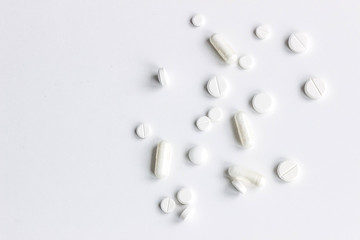 Background of white assorted pharmaceutical capsules and medication, copy space