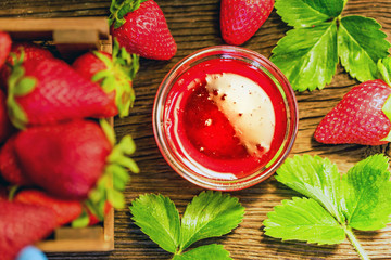 Fresh strawberries in wooden box and liqueur close