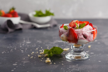 Strawberry dessert. English berry trifle, cheesecake, parfait. Berry mousse in glass on a dark background, copy space
