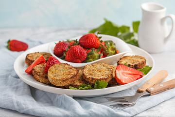 Vegan breakfast sweet tofu fritters (pancakes) with strawberries. Healthy vegan food concept.