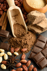 Cocoa powder, chocolate, nuts and spices on a wooden table. Food photography