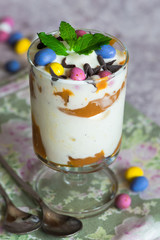 White chocolate ice cream and caramel dessert garnished with chocolate eggs and fresh mint