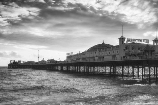 Beautiful blac kand white Winter sunset landscape of Brighton Pier on the south coast of England
