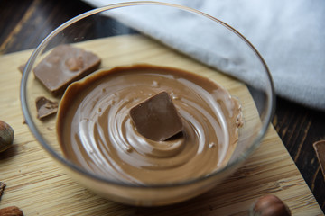Cracked chocolate pile on dark background with shallow depth of field