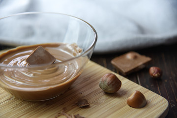 Cracked chocolate pile on dark background with shallow depth of field