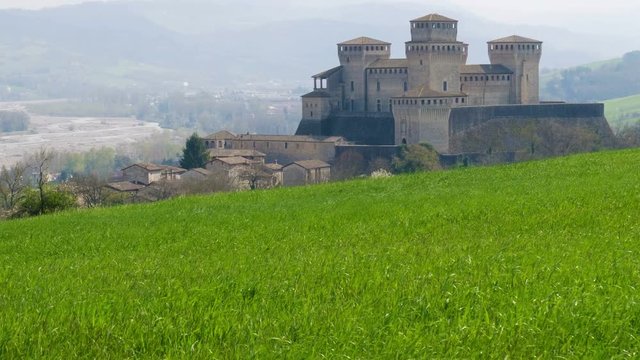 Parma - Italy - castle of Torrechiara meadow windy vale panorama - Emilia Romagna italian castle .