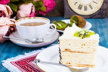 Piece of homemade cake with kiwi and whipped cream