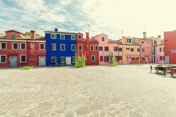 Small, cozy courtyard with colorful cottage /  Burano, Venice/ The small yard with bright walls of houses.
