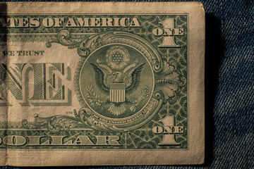 Obraz premium Amarican money Dollar in blue jeans pocket denim background texture.