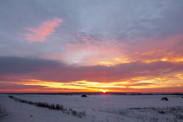 Majestic sunset in the winter landscape. Fantastic morning landscape glowing by sunlight. Dramatic wintry scene. Natural park.