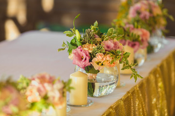 Beautiful table set with candles and flowers for a festive event, party or wedding reception