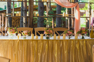 Beautiful table set with candles and flowers for a festive event, party or wedding reception