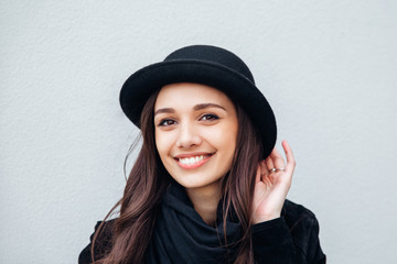 Smiling urban girl with smile on her face. Portrait of fashionable gir wearing a rock black style having fun outdoors