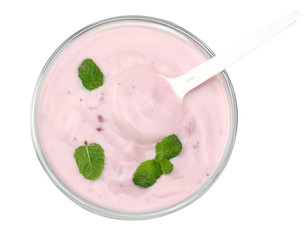 Healthy raspberries yogurt with mint leaves isolated on white background. Top view.